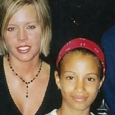 Sasha is wearing a red head band while the mother is wearing all black dress. 